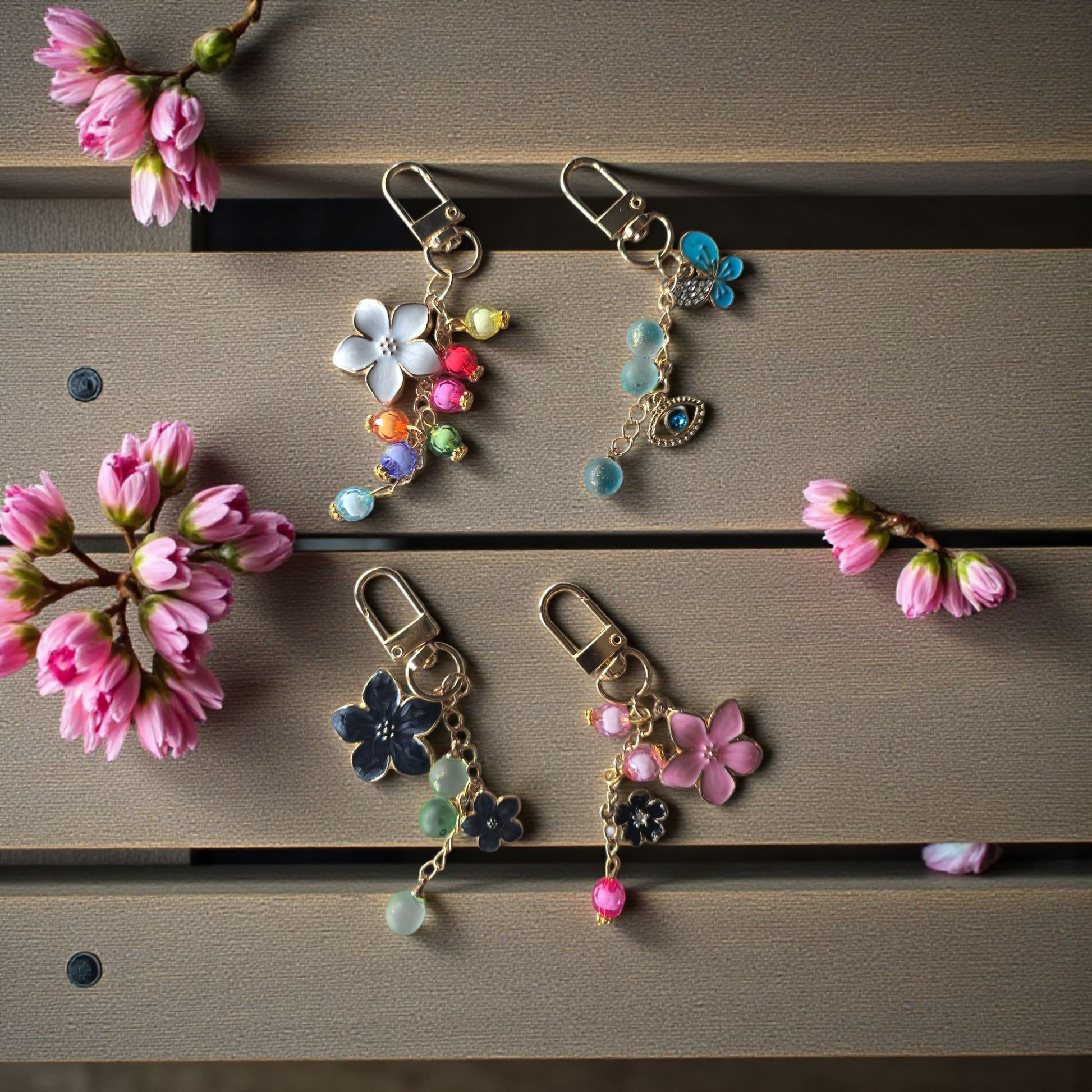flatlay of long disc key charms by dream.design.bloom featuring Whisper Dreams, Azure Blooms, Arbor Designs and Celestial Blooms, boutique discbound planner accessories