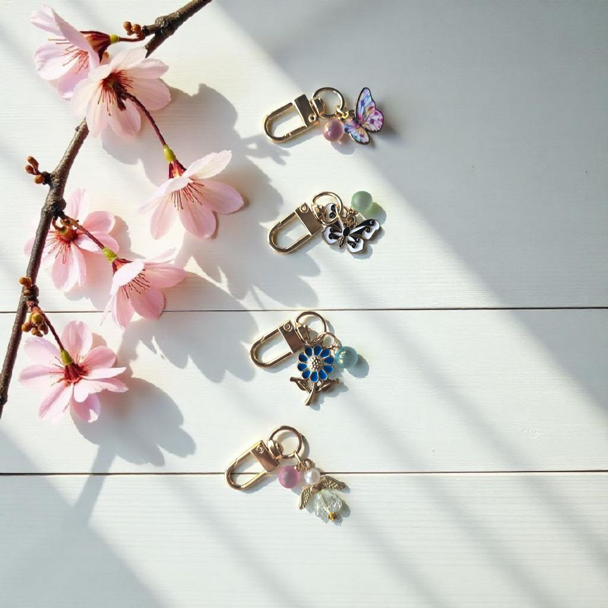flatlay of short disc key charms by dream.design.bloom featuring Whisper Dreams, Azure Blooms, Arbor Designs and Celestial Blooms, boutique discbound planner accessories