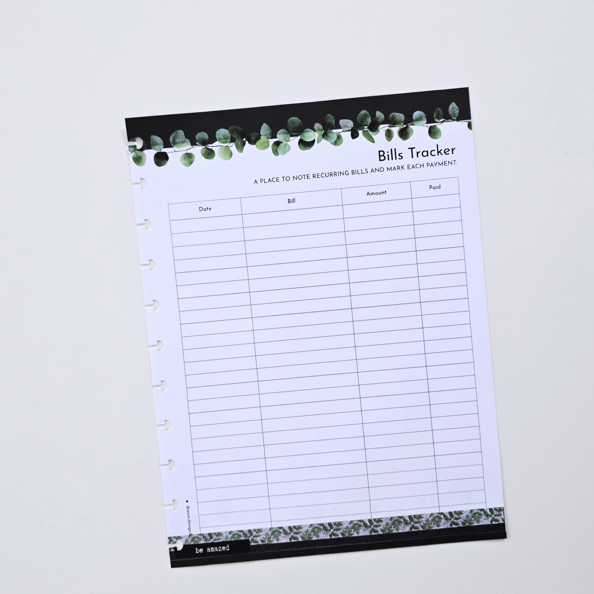 A single-page Bills Tracker discbound planner inserts with a black header decorated with green eucalyptus leaves, displayed on a clean white background. Disc Bound Planner.