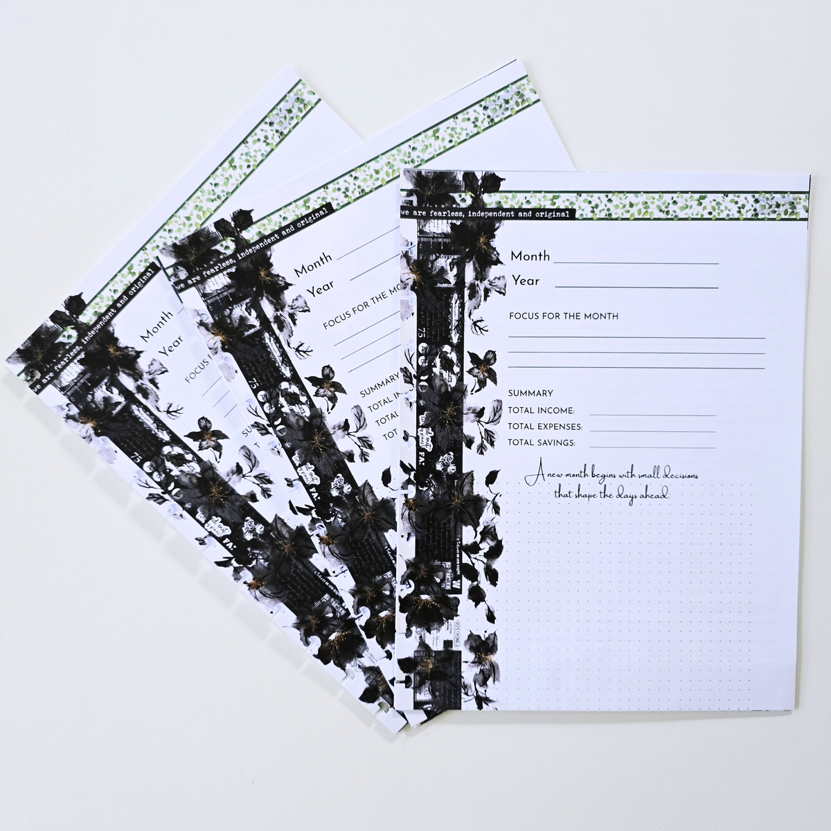 Three overlapping monthly budget planners with black lace and floral borders, displayed on a clean white background. Disc Bound Planner. Discbound Inserts