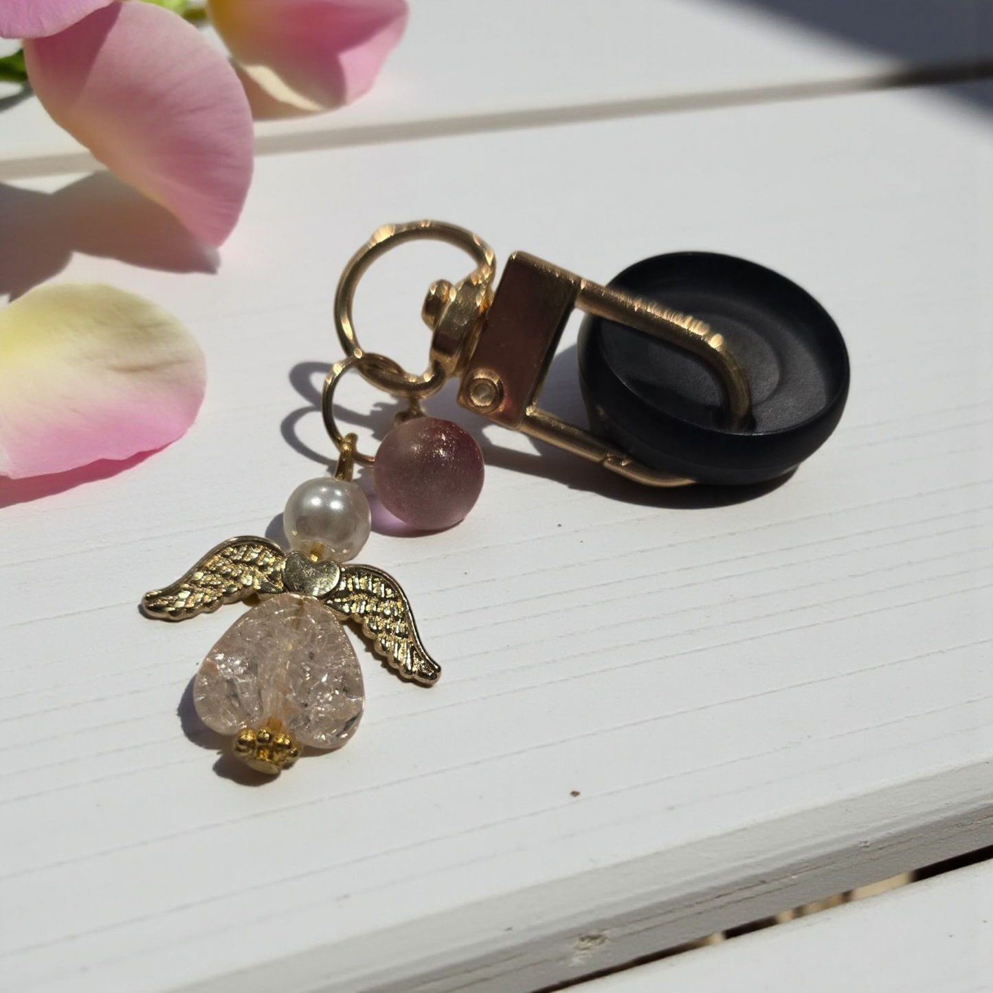 Whisper Dreams disc key charm by dream.design.bloom displayed on a black disc, boutique discbound planner accessory in soft pink palette
