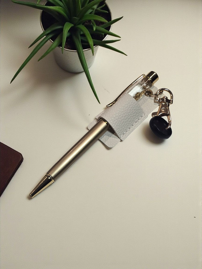 Disc Pen Holder by dream.design.bloom in white, shown holding a pen, boutique discbound planner accessory for minimal design lovers