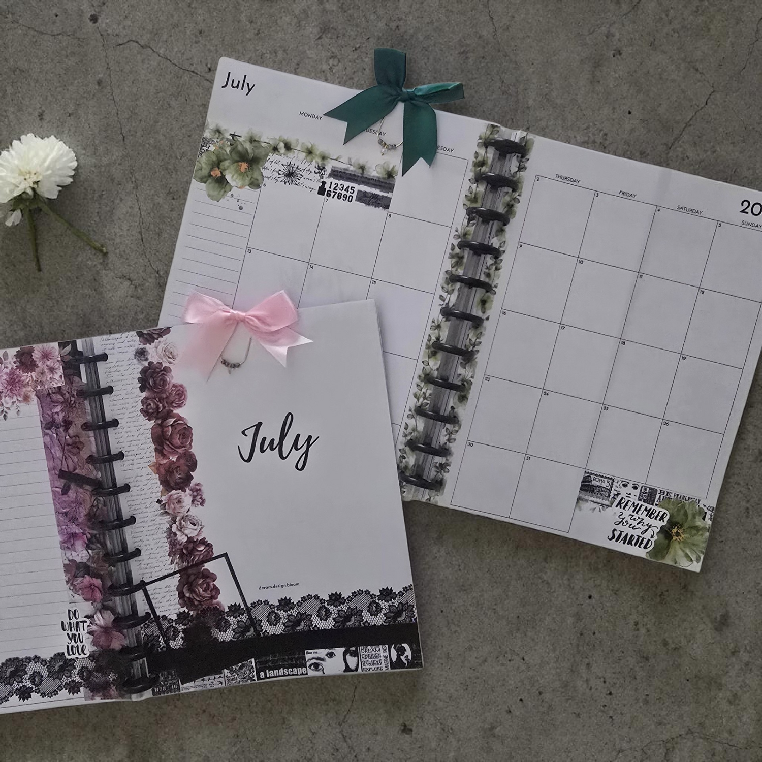 Two discbound planners with floral designs and ribbons on a concrete surface