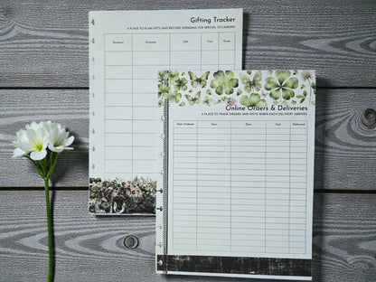 Two planner sheets on a wooden surface with a flower.