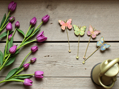 Flatlay of gold butterfly planner bookmarks by dream.design.bloom featuring Whisper Dreams, Azure Blooms, Arbor Designs and Celestial Blooms colour palettes
