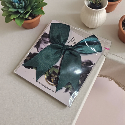 Packaged Large Paperclip with Bow by dream.design.bloom in Arbor Designs palette, boutique discbound planner accessory in green finish